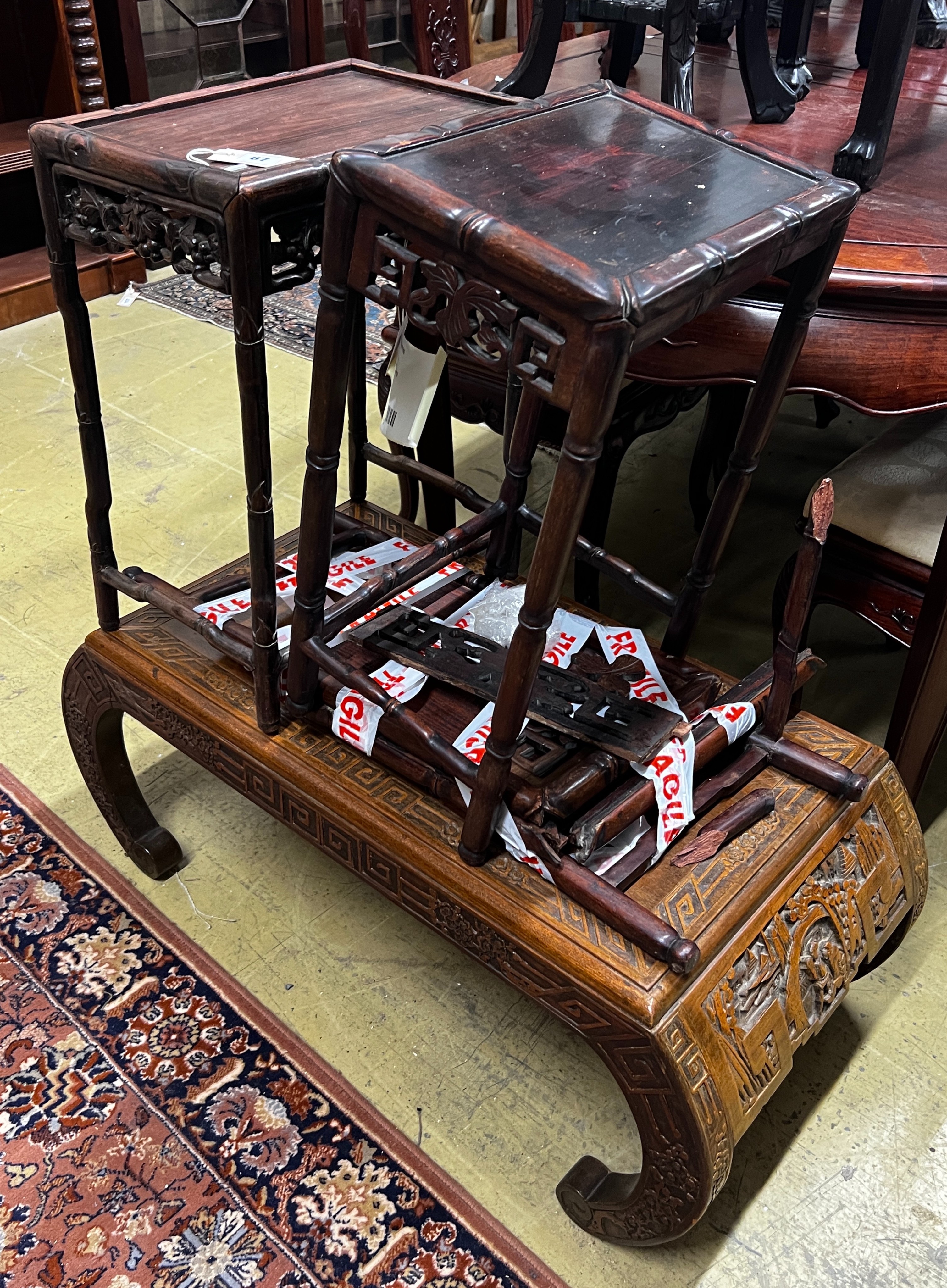 A Chinese carved hardwood low table, length 89cm, depth 43cm, height 36cm together with three Chinese carved hongmu occasional tables (one in need of extensive repair)